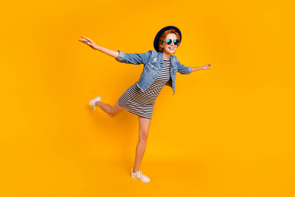 Full length body size view portrait of nice pretty lovely charming attractive cheerful cheery optimistic girl flying on air like plane free time isolated over bright vivid shine yellow background - Фото, зображення