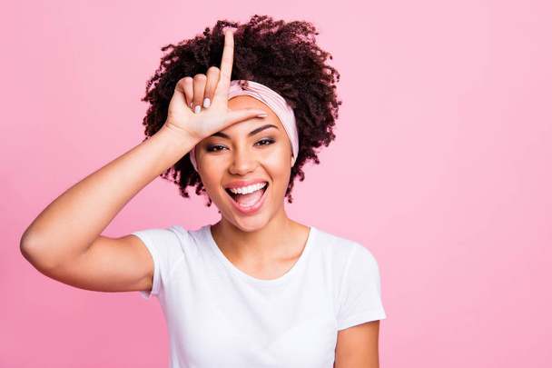 Close up photo beautiful amazing funny she her dark skin lady bad person bully making behavior symbol loser forehead impolite wear head scarf casual white t-shirt isolated pink bright background - Foto, immagini