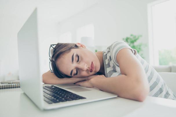 Close up photo beautiful she her lady notebook table sleepy eyes closed head lying arms hands sleepless night wait skype call wear jeans denim striped t-shirt comfort chair house living room indoors - Fotoğraf, Görsel