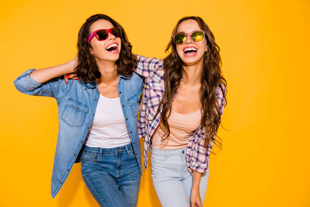 Portrait beautiful cute charming teen teenagers satisfied content chill laughter touch hair free time weekends summer travel holidays spring dressed checked shirt denim isolated yellow background - Fotoğraf, Görsel