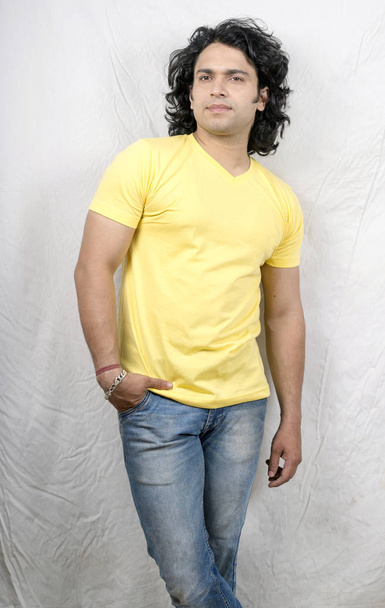 indian model wearing blue jeans and yellow tshirt - 写真・画像