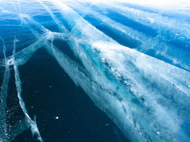 Cracks on slippery, smooth ice surface of a Baikal lake in Siberia (Russia) - Zdjęcie, obraz