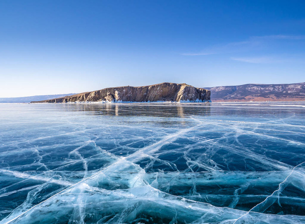 Transparent ice on Lake Baikal near Zamogoy island. Siberia, Russia - Foto, afbeelding