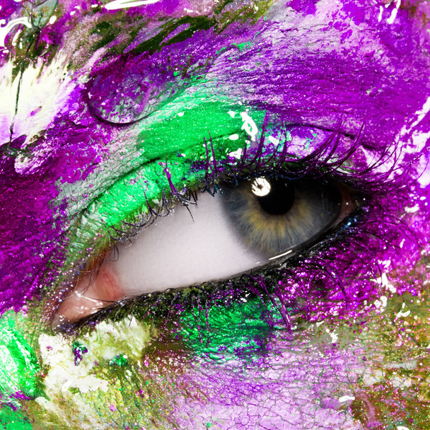 Beauty, cosmetics and makeup. Magic eyes look with bright creative make-up. Macro shot of beautiful woman's face with perfect art make up. Closeup of female eye. Body art - Photo, Image