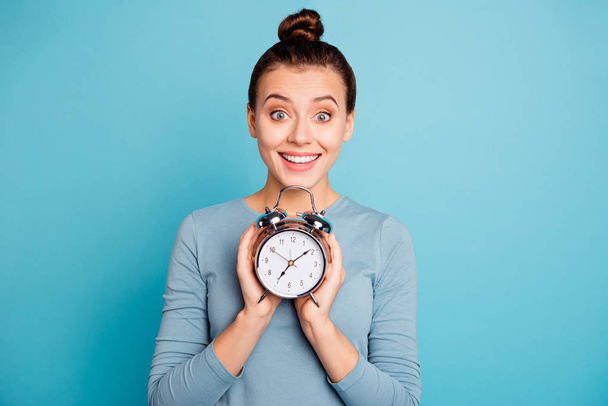 Close-up portrait of her she nice-looking attractive winsome lovely cheerful cheery funny girl holding in hands retro vintage clock isolated over bright vivid shine turquoise background - Fotó, kép