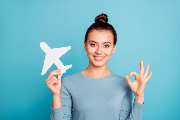 Close up photo beautiful she her lady hands arms hold paper airplane going abroad first time advising customers okey symbol use airline wear casual sweater pullover isolated blue bright background - Zdjęcie, obraz