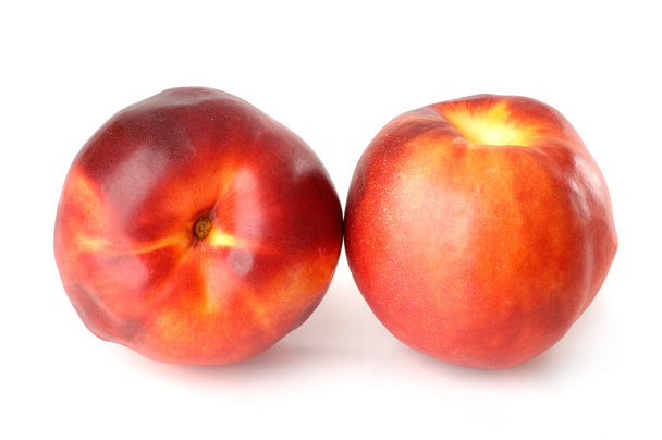 Two red nectarine peaches isolated on white back - Fotoğraf, Görsel