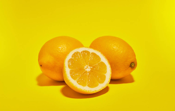 Lemon on yellow background. ��opy space . Food concept. - Φωτογραφία, εικόνα