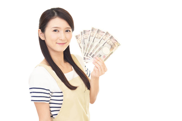 Smiling Asian housewife with money - Photo, Image