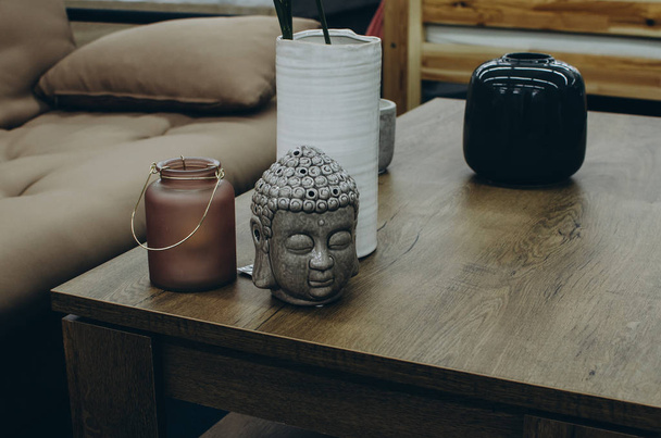 Home decor with buddha head on table - Фото, зображення