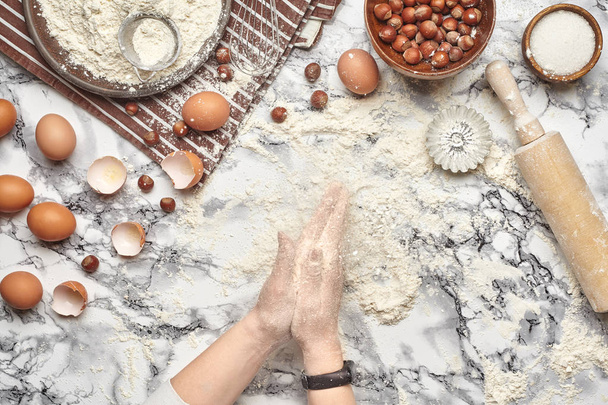 Close-up shot. Top view of a baker cook place, hands are working with a raw dough on the marble table background. - Fotoğraf, Görsel