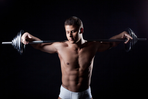 Portrait of attractive guy posing with barbell - Photo, image