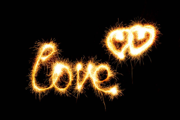 Valentines Day - Love made a sparkler on black background - Photo, Image