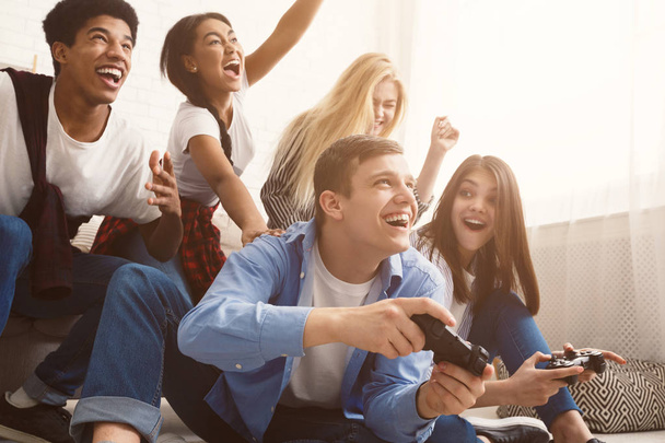 Teenagers having fun, playing video games online - 写真・画像