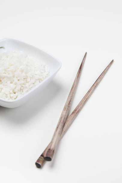 Bowl of white rice isolated on white - Фото, изображение