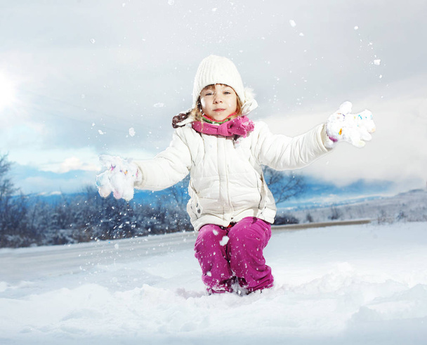 Portrait of cute little girl in winter - Фото, изображение