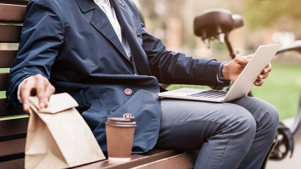 Lunch break. Businessman sitting outdoors with laptop - Zdjęcie, obraz