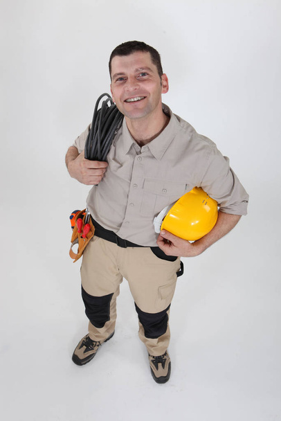 Electrician with a reel of cable - Fotó, kép
