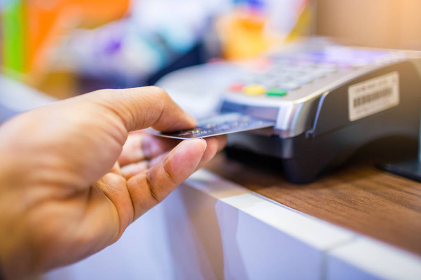 Hand put credit card In slot of credit card reader, credit card  - Photo, Image