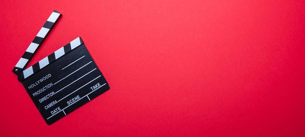 Movie clapperboard on red color background, banner, top view - Photo, Image