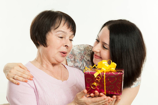the woman gives to mother a gift - Foto, Imagen