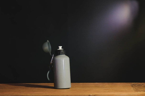 Still life water bottle and light ray on table. - Fotografie, Obrázek