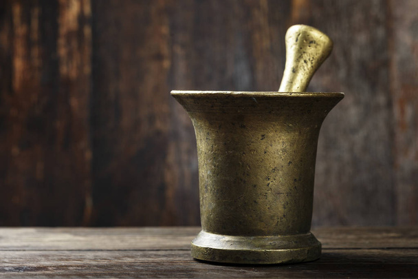 brass mortar on the table - Foto, Imagen