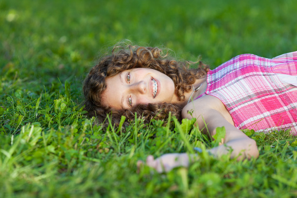 Happy Teenage Girl Lying On Grass - Photo, image