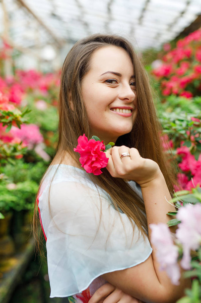 portrait of a beautiful young woman with flowers - Zdjęcie, obraz