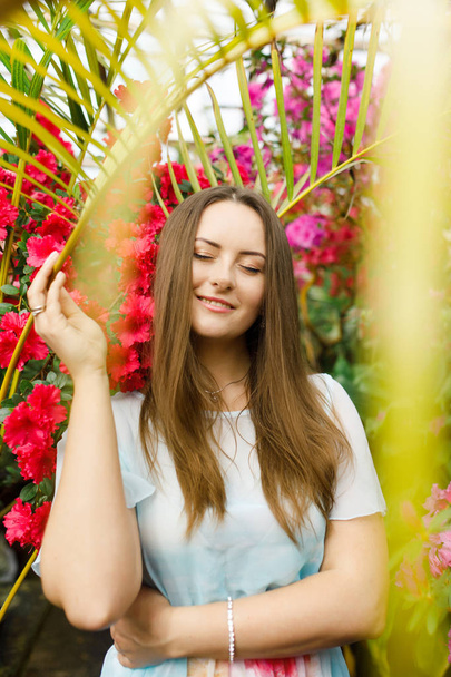 beautiful young woman in a wreath of flowers - Фото, зображення