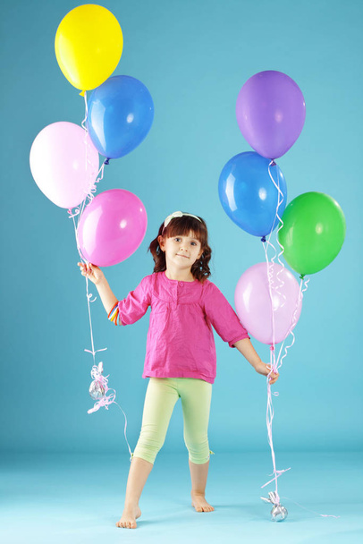 Child with colorful air ballons over blue - Photo, Image