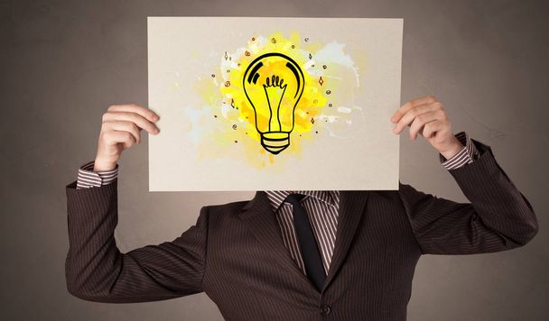 Person holding a paper with colorful bulb concept - Photo, Image