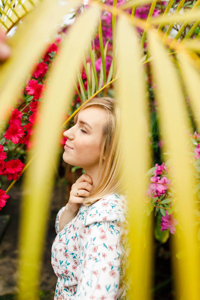portrait of a beautiful young woman in a summer garden - 写真・画像