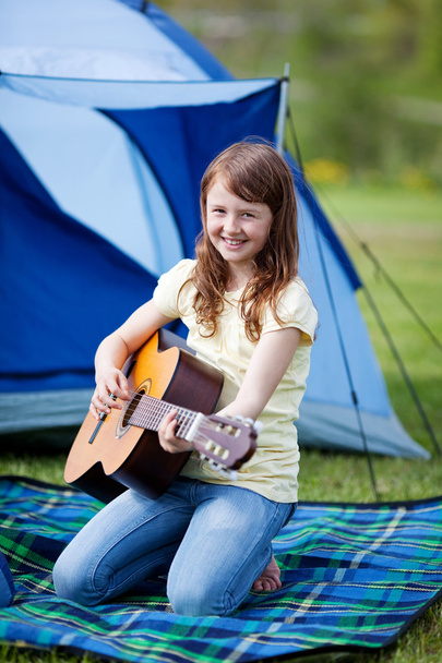 Smiling Girl Playing Guitar Against Tent - Photo, image