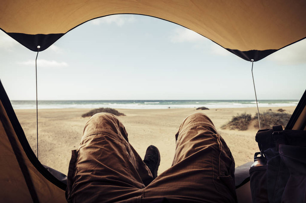 člověk v turistických šatech, které leží venku stanování na pláži  - Fotografie, Obrázek