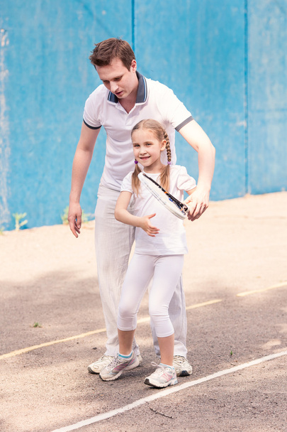 Instructor teaching a child how to play tennis - Photo, image