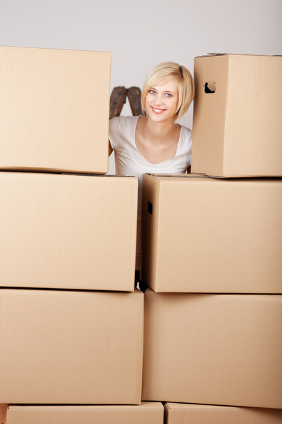 Woman Behind Stack Of Cardboard Boxes - Zdjęcie, obraz