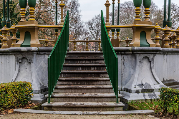 Stairs to the picturesque kiosk in Koningin Astridpark (Park of the Queen Astrid) in Bruges, Belgium. Surrounding trees and bushes make it a somewhat secluded place. - Photo, Image