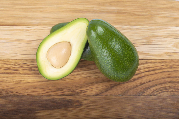 Avocado on a wooden board cut in half - Photo, Image