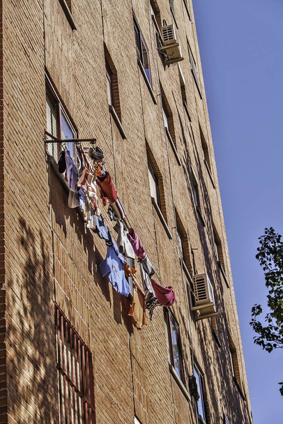 Madrid, August 2012. Laundry drying on a window in a residential building - Фото, зображення