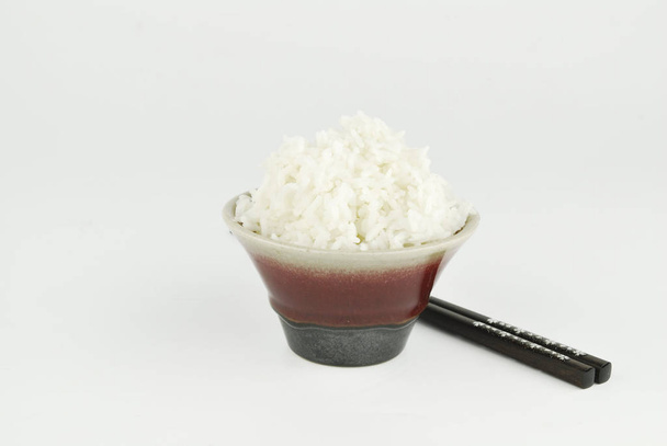 Rice in bowl and chopstick on white background - Photo, Image