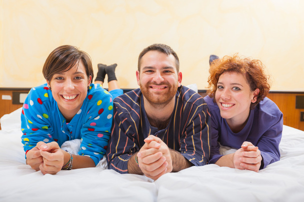 Man with two women on the bed - Φωτογραφία, εικόνα
