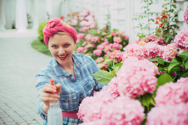 woman care of flowers in garden. happy woman gardener with flowers. Flower care and watering. soils and fertilizers. Greenhouse flowers. hydrangea. Spring and summer. Nature needs your care - Photo, image