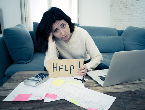 Stressed and overwhelmed young woman accounting home finances paying bills asking for help - Foto, Bild