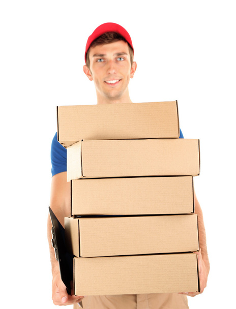 Young delivery man holding parcels, isolated on white - Foto, immagini