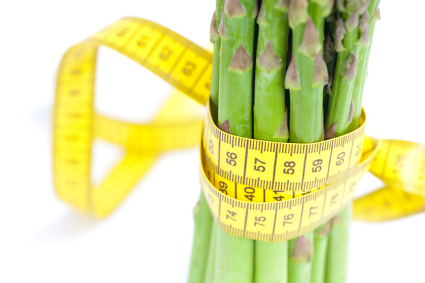 asparagus tied with measuring tape isolated on white - Photo, Image