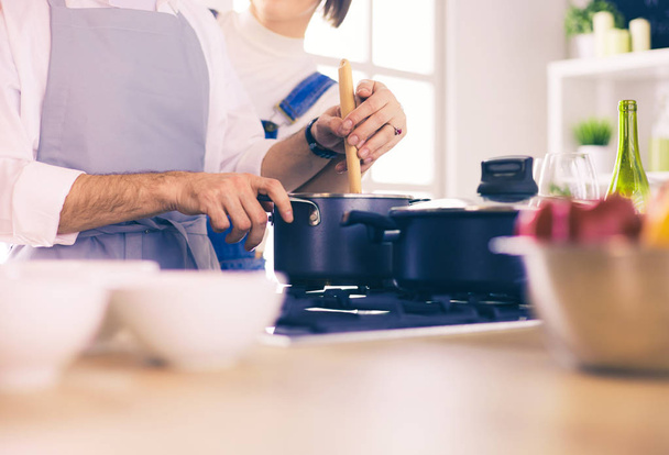 Couple cooking together in the kitchen at home - 写真・画像