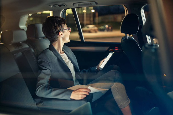 business woman traveling with car by night on business trip - Fotografie, Obrázek
