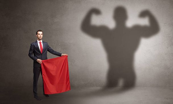 Businessman with strong hero shadow and toreador concept - Photo, Image