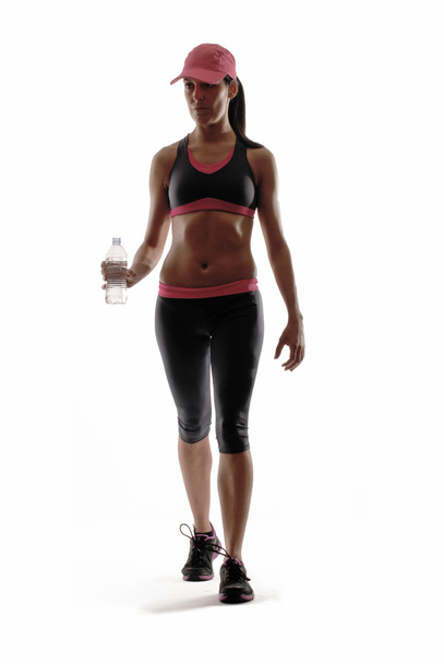Portrait of young woman wearing sport clothes and drinking water - Foto, Bild
